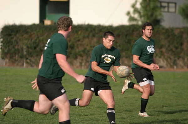 Joe Romo (center) flanker and captain of the Sac State Rugby team catches a pass while running drills with team members on Thursday afternoon. February 19, 2009 - Ashley Knight: