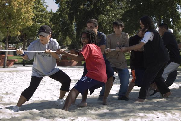 Kazue Masuyama, Japan Club adviser and Devin Stagg, junior business major lead the pack in a game of Tug of War during the Japan Club event Taiiku No Hi on Friday in Swanston Park. :
