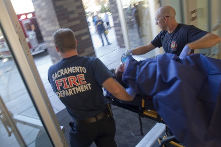 Sacramento Fire personnel take away Sacramento State student Scott Hawkins following an attack by his suite mate, Quran Jones, at the American River Courtyard residence hall wednesday afternoon. Hawkins later died in the hospital.:Adalto Nascimento - State Hornet
