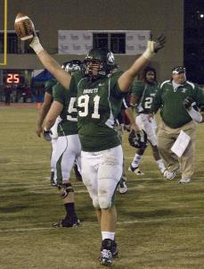 Senior defensive lineman Kevin Moore holds up the football after Sac State took over the lead in the final minutes of the game. This marks the Hornets second win in a row for the Causeway Classic held this year on Nov. 21.: