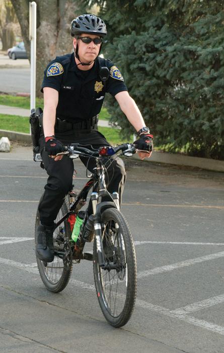 Bike Cops:Officer Nathan Rice patrols the campus on his bicycle. :Nallelie Vega - State Hornet