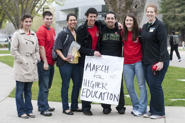 march:CSU trustee Nicole Anderson, second from right, and ASI members gathered before marching to the Capitol from Raley field. :Mia Matsudaira - State Hornet