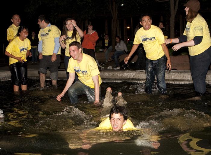 voteimpact2:Members of the student organized political party, Vote Impact!, celebrate their victory Wednesday night in the Library Quad water fountain.:Adalto Nascimento - State Hornet