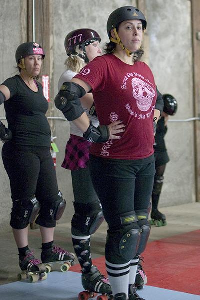 roller derby 1:Nelly Wollenberg, senior Spanish major, known by her deby name, Attila The Honey waits in line for drills during practice Thursday.:Robert Linggi - State Hornet