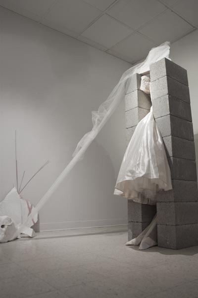 The Last Wedding:A wedding dress stands between two concrete block pillars in the Else Gallery in Kadema Hall as part of Marianne Ryan?s ?The Last Wedding, Part 1: In Progress.? Bottom left: Ryan used balanced stones in her exhibit.:Chris Chang - State Hornet