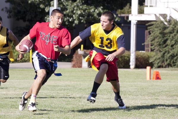 recsportsfootball:Henry Castro from the Sigma Phi Epsilon fraternity runs the ball during a recreational game. Recreational football is one of the many activities Campus Recreation offers. :Brittany Bradley - State Hornet