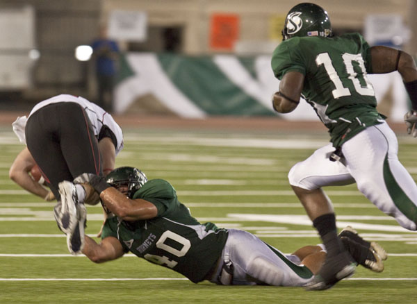 football1:Peter Buck (40) tackles the Western Oregon Universitys quarterback at Saturday nights football game in Hornet Stadium.:Julie Keefer - State Hornet