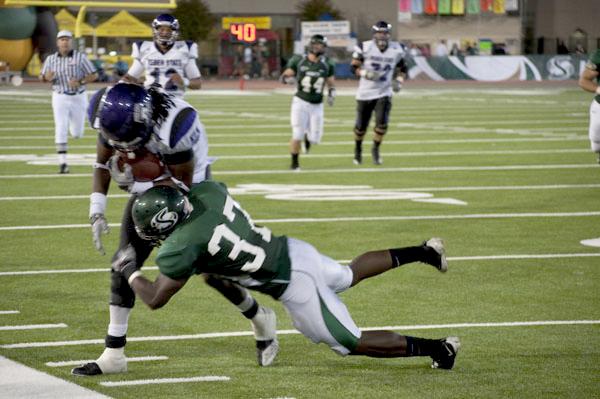 Football vs. Weber State 1:Hornets and Wildcats colide in a tackle during a game Saturday at Hornet Field. The Hornets won 24-17. :Robert Linggi - State Hornet