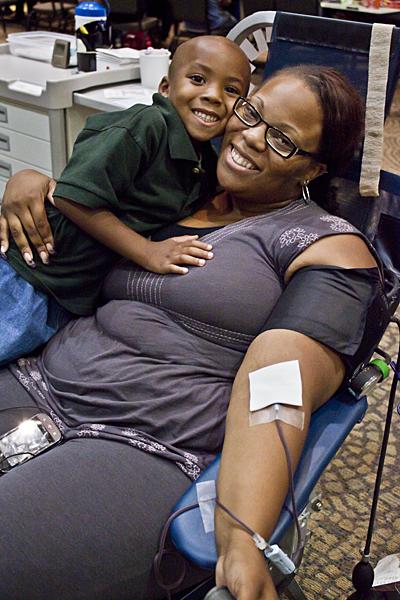 CSU Blood Drive 1:Amber Dennis, a senior liberal studies major, takes time out of her day to save lives by donating blood in Wednesdays Causeway Classic Blood Drive. Her son Jaylen keeps her company in Sacramento States University Union Ballroom.:Ashley Neal - State Hornet