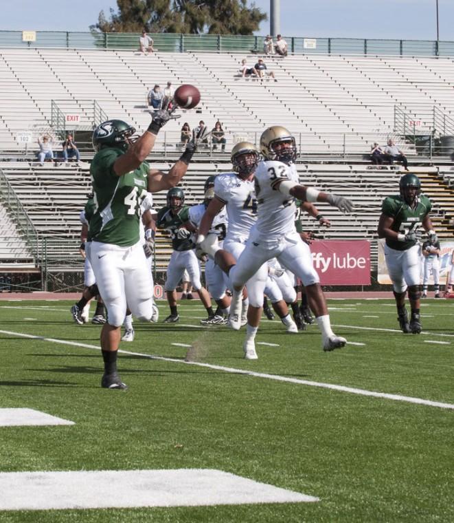 Football vs. UNCO 2:Junior Stephen Tezanos-Pinto catches a touchdown pass from quarterback Jeff Fleming during Saturdays game. The Hornets won 42-7.:Steven Turner - State Hornet