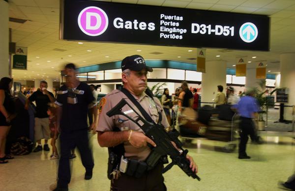 airport security:Miami Dade Police officer Mark Huetter walks the concourse at Miami International Airport.:McClatchy Tribune