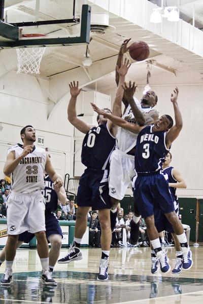 sac state mens basketball:During Friday nights game, Hornets forward Zach Nelson (center) springs for the rebound after a free throw from his teammate. The game took place in the Hornets Nest and ended in a win for Sac State with a final score of 83 - 65.:Ashley Neal - State Hornet