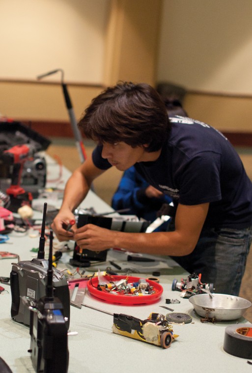 Robot Rumble:Junior civil engineering major Bryant Ho works on one of the robots available for public demonstration at the Robot Rumble Sunday in the University Union Ballroom.:Steven Turner - State Hornet 