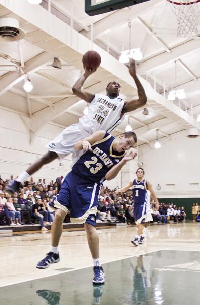 Men's basketball comes up short 61-54 against Davis :Hornets? forward Zach Nelson flies over his opponent Josh Ritchart and adds two more points to the scoreboard. The game was against UC Davis and ended with a loss for Sac State with a final score of 61-54. :Ashley Neal - State Hornet 