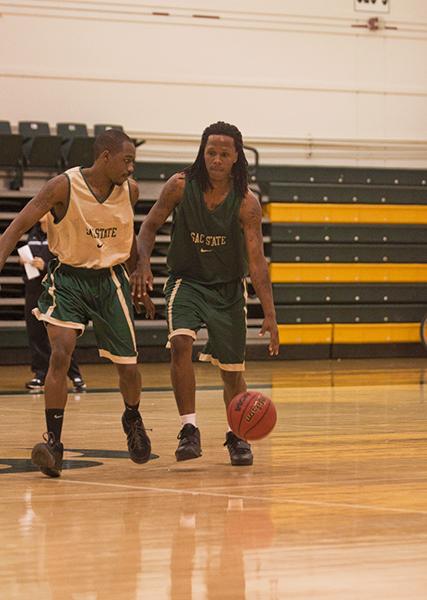 mens basketball 1:Antoine Proctor dribbles around the defender during practice.:Daniel Ward - State Hornet