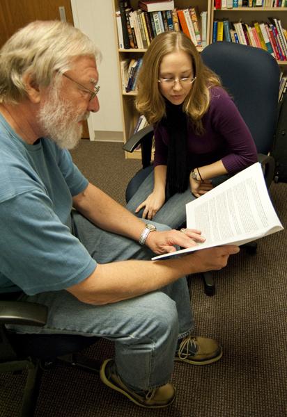 Louis Downs :Counseling education professor Louis Downs shares his disaster relief training manual with graduate student Debbie Morales.:Becky Bell - State Hornet 