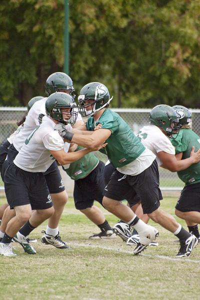 Big Sky Conference:Defensive linebacker Zach Nash runs blocking drills against the offensive line during practice.:Brittany Bradley - State Hornet