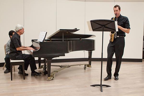 Cozza 1:Campus accompanist John Cozza practices with saxophonist Keith Bohm during a rehearsal in August.:File photo