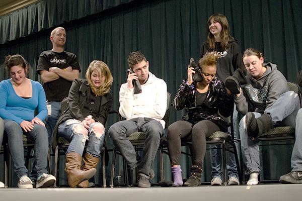 Students participate in hypnotist show:Sacramento State students use their shoes as a way to listen to music during Tom Deluca?s hypnotist show on Thursday. Students also went in front of the crowd and performed as cheerleaders and singers.:Nicole Lundgren - State Hornet