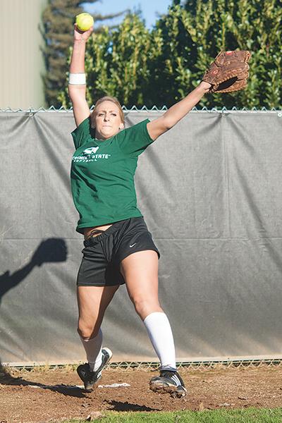 Softball 1:Top: Shelby Voelz, a junior pitcher, works on conditioning her arms and her reflexes for the upcoming softball season.:Jesse Charlton - State Hornet