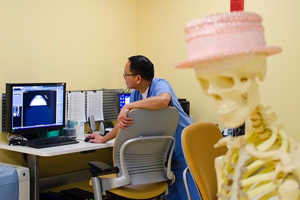 Radiological technologist Orlando Castro views X-ray files :Radiological technologist Orlando Castro views X-ray files on the Health Center?s new computerized system.:Robert Linggi - State Hornet