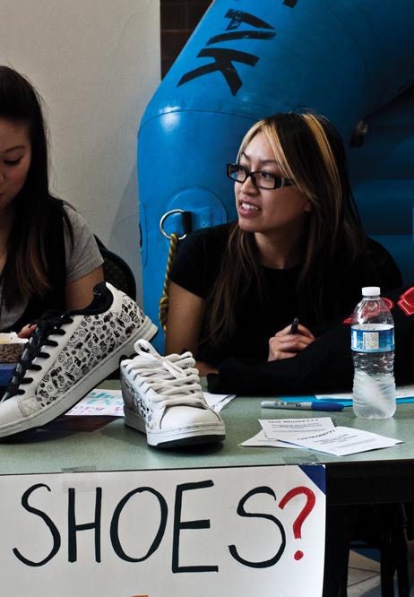 Tina Dang collects shoes for Got Shoes??? drive:Tina Dang of Alpha Phi Omega receives shoes at the Got Shoes??? fundraiser.:Jesse Charlton - State Hornet