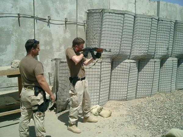 Vet firing rifle:Matthew Ceccato, senior international communications major, fires an AKM assault rifle while on duty in Iraq.:Courtesy Photo