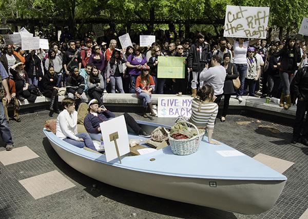 Students in yacht at protest:Students acting as Sacramento State administrators pretend to ride in a yacht during a demonstration Wednesday in the Library Quad.:Robert Linggi - State Hornet