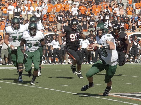 
Hornets’ quarterback Jeff Fleming (18) races down field
during Saturday’s game against Oregon State in Corvallis, Ore. The
Hornets beat the Beavers in overtime resulting in one of the
biggest wins in Sacramento State history.
