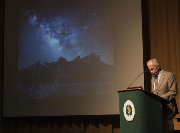 Dr. Dale Russell, an adjunct professor, begins the STEM Scholars
Lecture: Worlds to Discover, Exploring the Galaxy for Dinosaurs
with an image of the Milky Way on Tuesday.
