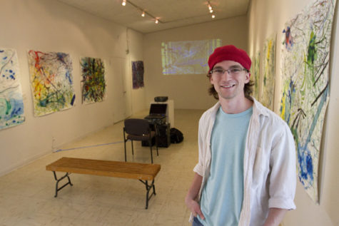 Senior studio art major Alex Booze prepares to greet visitors at
the Witt Gallery Monday, with a reception to see his work, “New
Wave” by Alex Booze.