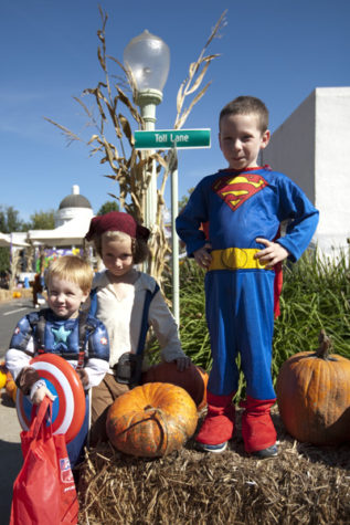 Super heroes Damian (left), Ashton (center) and Christopher
(right) gathered at the corner of Toll Lane and Main Street in
Safetyville on Saturday.