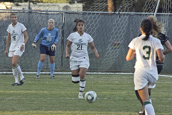 Jessica Castano runs down field as defender Laura Bahno, No. 3,
and goalkeeper Savannah Abercrombie anticipate her next move.
