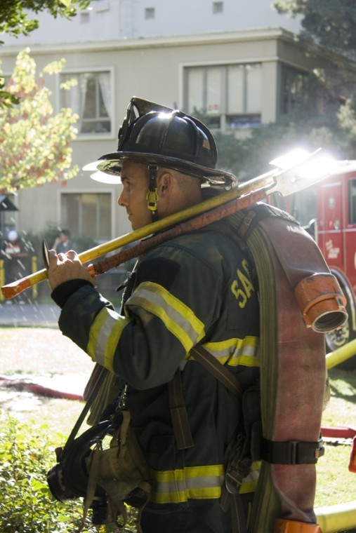 A Sacramento Fire Department firefighter in full gear, prepares
to battle the flame on the smoke-filled fifth floor of Mendocino
Hall Thursday, which did not suffer as much damage as the fourth
floor of Mariposa Hall. 
