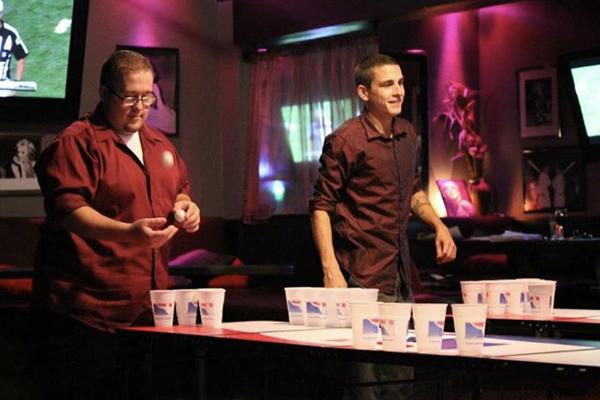 
Jacob Scandone, right, competes in a water pong tour- nament at The
Station Bistro and Lounge on Sept. 28.
