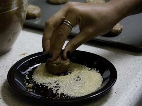 Daniels gingerly coats the tops of the vegan cookies with
granulated sugar.