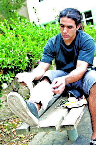 Jacob Kessler, a Sacramento State student and avid BMXer, sits
down on a bench waiting for a friend to pick him up for a hospital
ride.