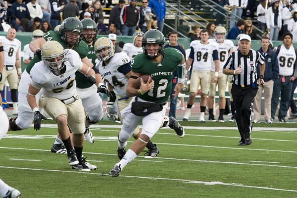 Freshman quarterback Garrett Safron runs against UC Davis during
the 58th Causeway Classic at Hornet Stadium on Saturday.
