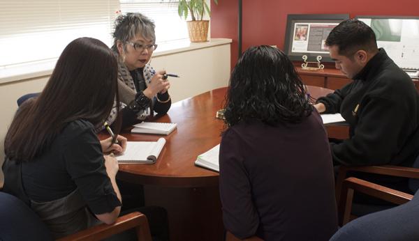 Carole Hayashino, vice president for University Advancement, is
in a meeting to plan an event with commencement and special events;
Coordinator Tess Simas, Mimi Phothichack and advancement assistant
R. Paul Villaluz.  
