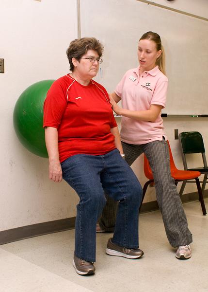 Julia Sheremet, a second year physical therapy graduate student,
helps Annette Morehouse stretch after working on her walking
endurance, during one of the Friday mock clinics in Solano
Hall.
