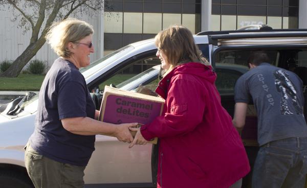 Volunteers help load cookies in to vehicles Saturday at the 2012 cookie drop.
