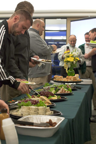 Sacramento State booster members and the football staff gather
to enjoy food and drinks in the Alumni Center on Wednesday,
football's signing day.