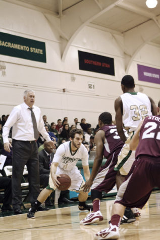 Junior guard Julian Demalleville is pushed against the sidelines
as he looks for the pass during the first half.