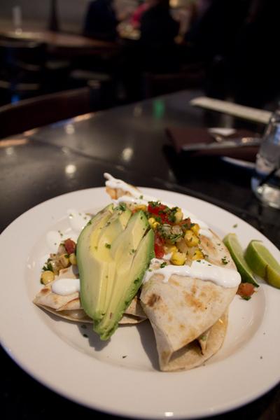The monterey jack cheese quesadilla served at The Porch
Restaurant and Bar consists of a topping of avocado slices, corn,
diced tomatoes, cilantro and sour cream. 
