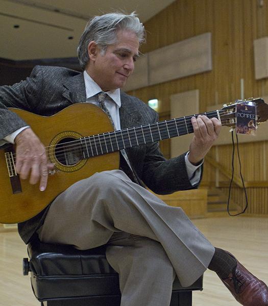 Grammy-nominated Professor Richard Savino strums his guitar
prior to instructing his History of Rock and Roll class. The Grammy
award ceremony will be held in Los Angeles on Feb. 12.
