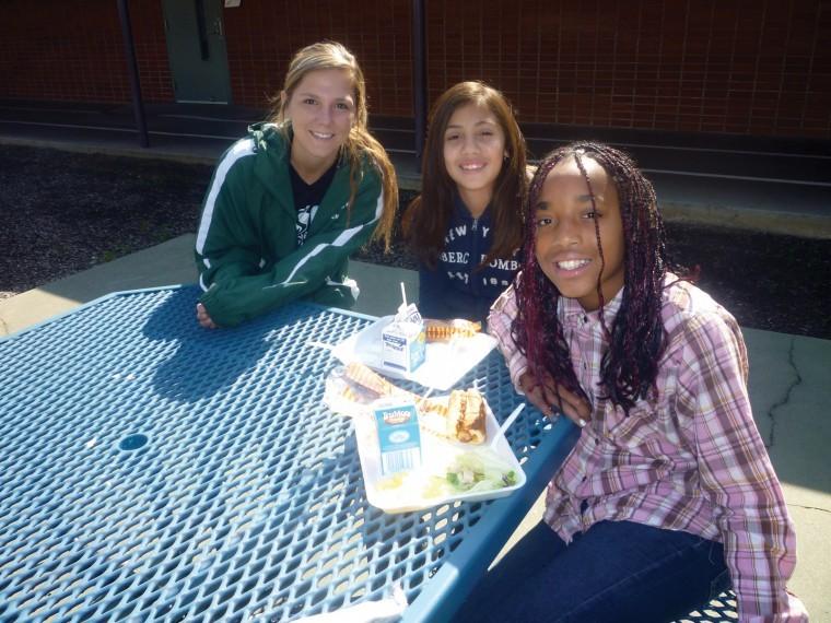 Gabriela Trenton of the Sacramento State women’s soccer team eats lunch with children at Howe Elementary.
