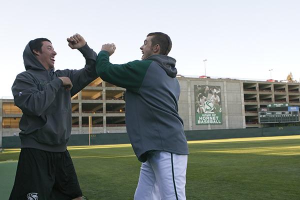 Redshirt freshman relief pitcher Ty Nichols and sophomore infielder Justin Higley participate in a daily handshake. Sacramento State’s baseball team practices an array of different handshakes involving many different moves.
