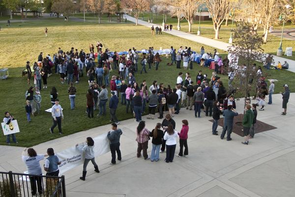 Several students gather outside The Well for a suicide prevention walk, drawings and guest speakers.
