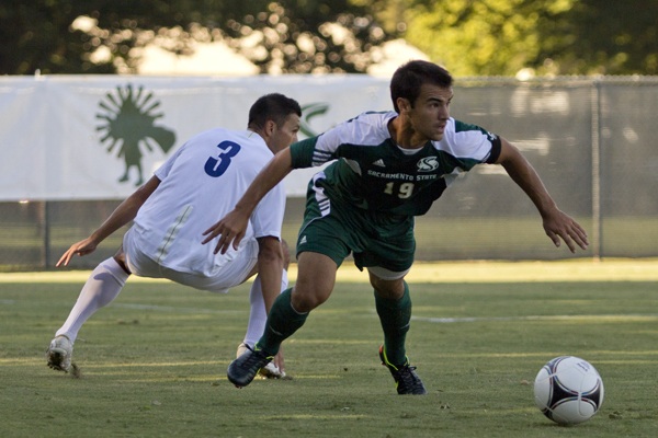 Sacramento State senior midfielder Alex Lopez tries to get away from San Diegos Matthew Chavez Friday at the Hornets home opener. The game went into overtime and Sac State won 2-1. 
