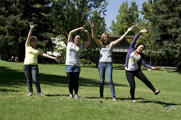 From left to right: Amanda McGinnis, Freshman, Nutrition; Christina Lee, Freshman, Business Administration; Stephanie Roach-Alberts, Freshman, Undeclared; Jeanie Yang, Freshman, Liberal Studies, spells out LOVE in the library quad.
